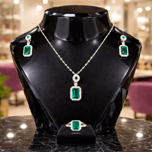 Hezel premium emerald jewellery set with necklace, earrings and ring on luxury display stand
