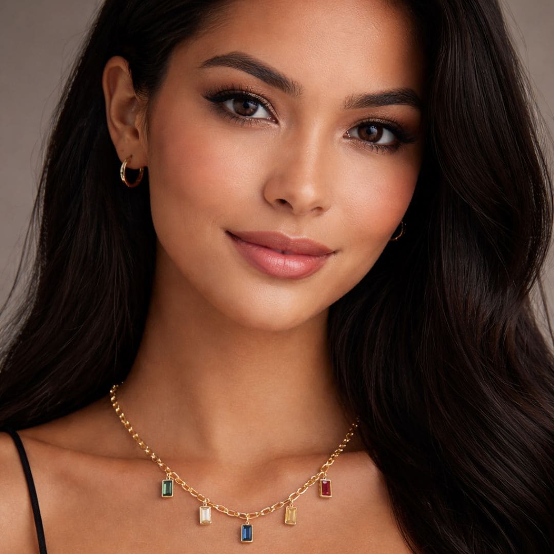 Model wearing HEZEL gold charm necklace with multicolor gemstone pendants on elegant chain