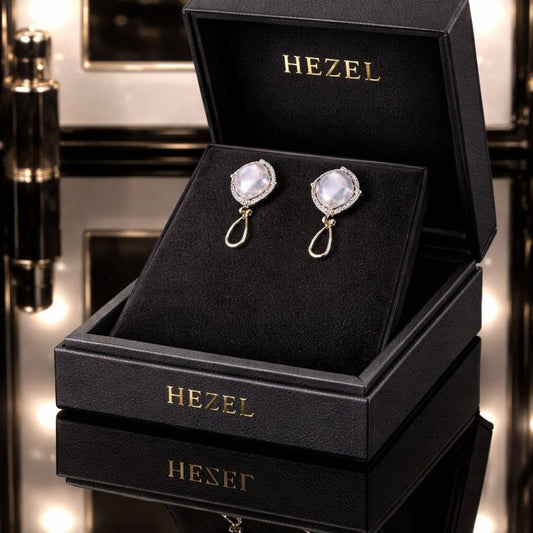 Hezel luxury silver drop earrings with iridescent stones displayed in premium black jewelry box