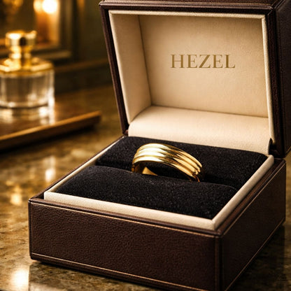 HEZEL gold band ring with multi-groove design displayed in premium leather jewelry box with elegant luxury background