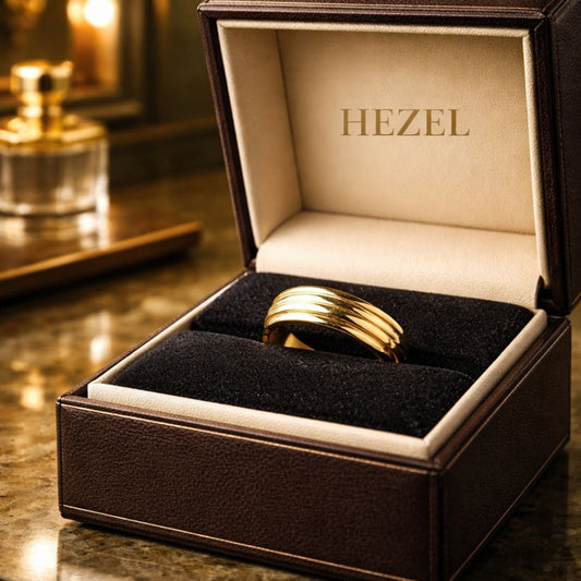 HEZEL gold band ring with multi-groove design displayed in premium leather jewelry box with elegant luxury background