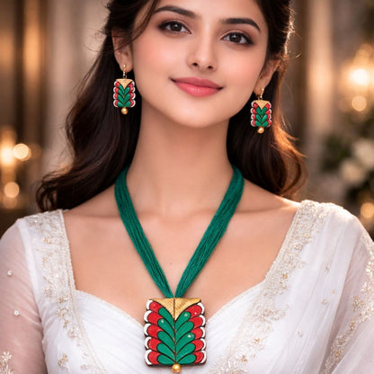 HEZEL green and red enamel necklace with matching earrings worn by female model in elegant traditional attire