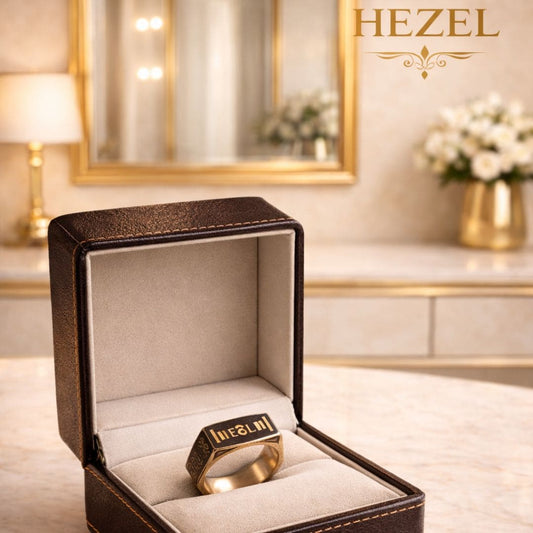 Gold signet ring in luxury brown leather jewelry box with Hezel branding