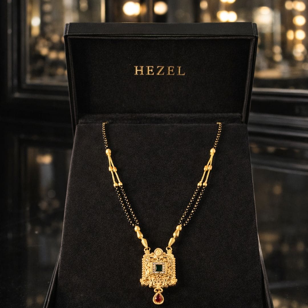 HEZEL traditional gold mangalsutra with elegant black beads and royal pendant showcased in a premium black velvet jewelry box with luxury festive background