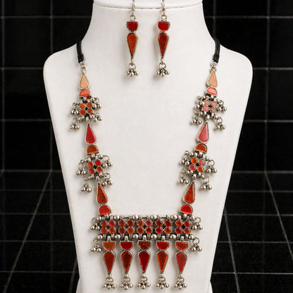 HEZEL oxidised silver-tone necklace set with red stone accents and matching drop earrings, displayed on a white jewellery bust