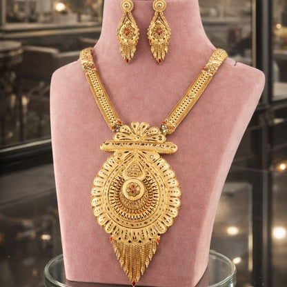 HEZEL traditional gold-tone statement necklace with intricate pendant and matching earrings, displayed on a premium mannequin.