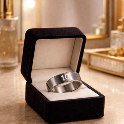 Hezel brand minimalist stainless steel band ring engraved with “10,” elegantly presented in a premium jewelry box with a warm, luxurious background
