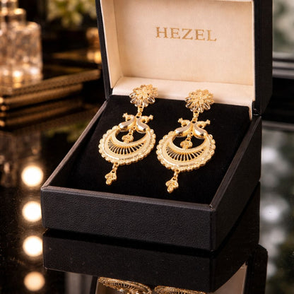 Hezel gold chandelier earrings displayed in luxury black jewelry box with branded interior