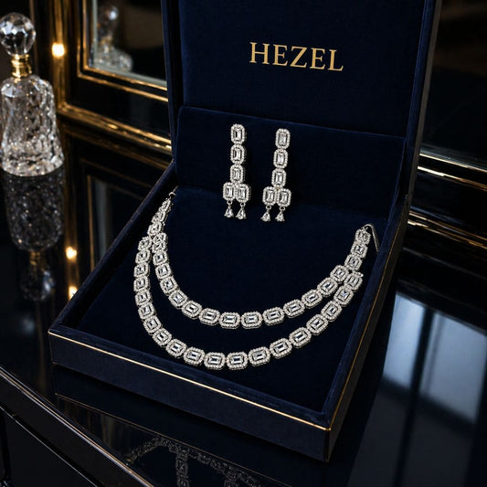Close-up of HEZEL silver crystal necklace set featuring geometric design and matching drop earrings