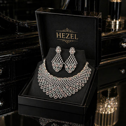 Hezel statement necklace set with pastel green and pink stones, paired with matching chandelier earrings in a premium black jewelry box