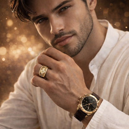 Hezel gold statement ring worn by a man with a luxury watch, styled in a warm, premium editorial setting.