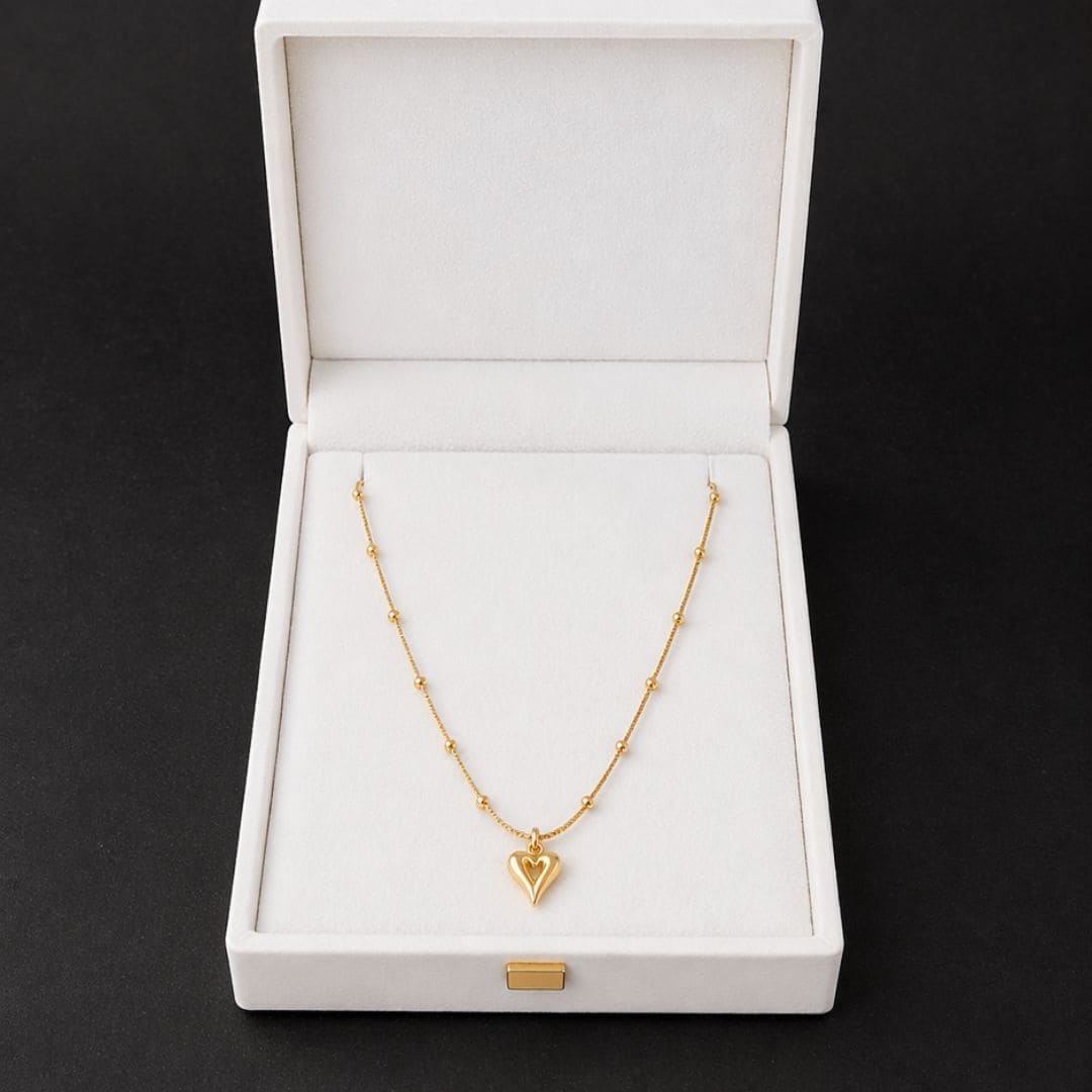 HEZEL gold heart pendant necklace in a premium white jewelry box, elegant minimal design