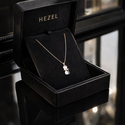 HEZEL cat pendant necklace in gold finish displayed in a luxury black jewelry box