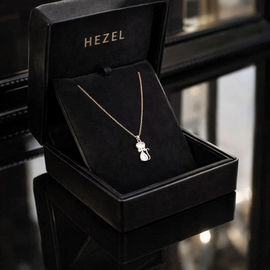 HEZEL cat pendant necklace in gold finish displayed in a luxury black jewelry box