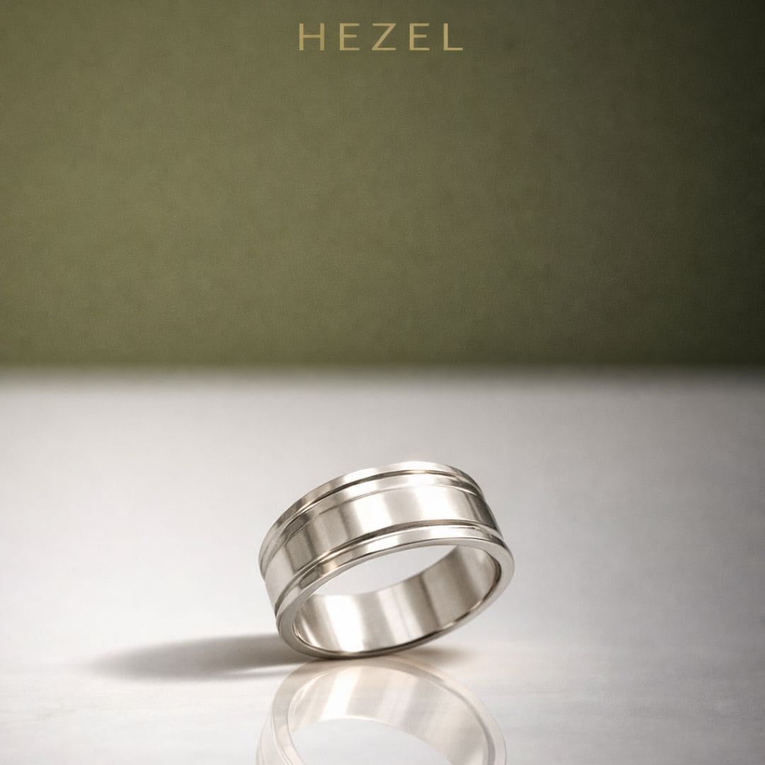 HEZEL minimalist silver band ring with dual groove design on reflective surface
