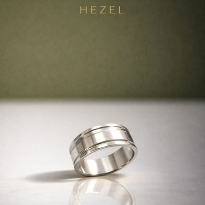 HEZEL minimalist silver band ring with dual groove design on reflective surface