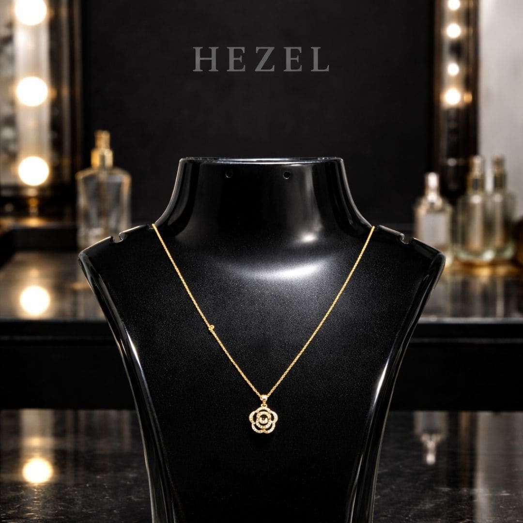 Elegant gold floral pendant necklace by Hezel displayed on black mannequin, luxury jewelry piece