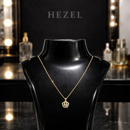 Elegant gold floral pendant necklace by Hezel displayed on black mannequin, luxury jewelry piece