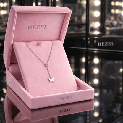 Elegant Hezel butterfly pendant necklace showcased in luxurious pink velvet jewelry gift box.