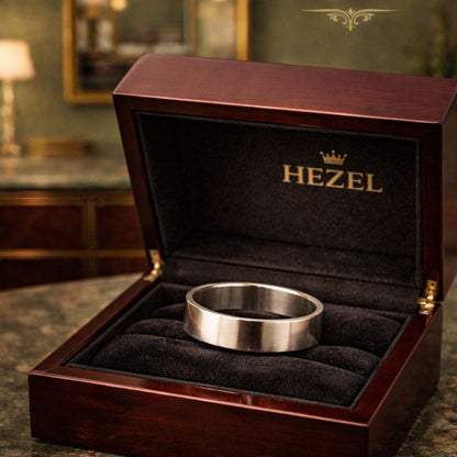 Sleek silver band ring presented in a premium wooden HEZEL jewelry box, emphasizing its refined craftsmanship and timeless minimalist appeal.