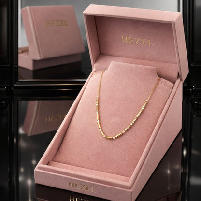 Minimal gold chain necklace in a premium HEZEL pink box, elegant and timeless everyday style.