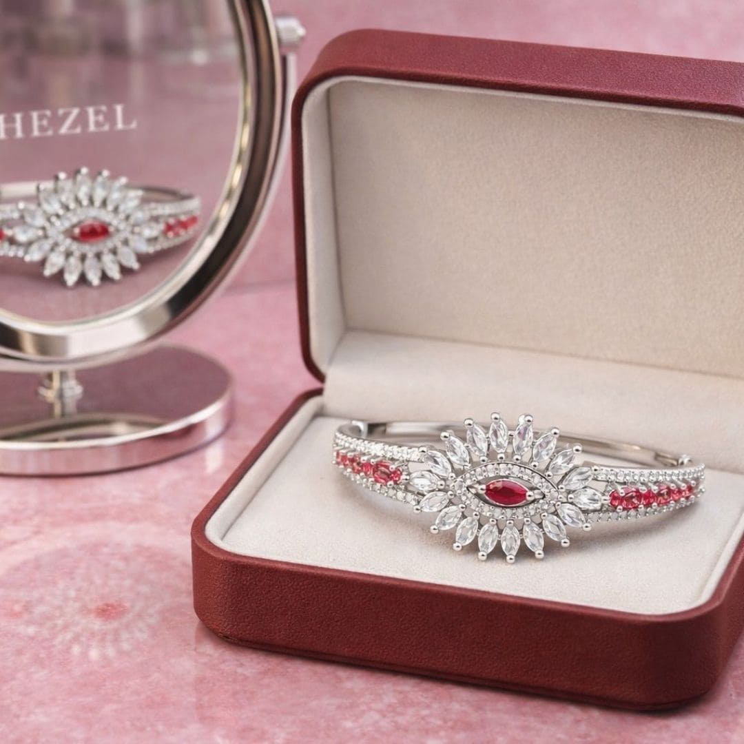 HEZEL floral silver-tone bracelet with ruby stones displayed in elegant luxury jewellery box.