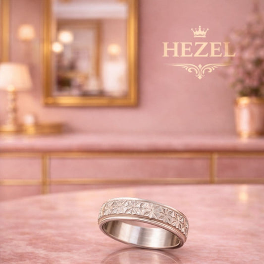 HEZEL textured silver band ring with intricate geometric pattern on marble surface in soft pink luxury setting