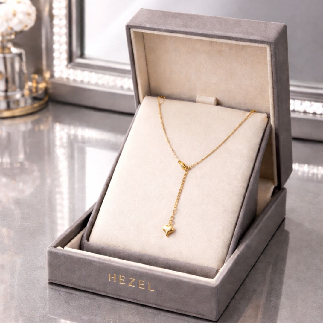 HEZEL luxury gold heart pendant necklace in premium velvet jewelry box with elegant mirror background