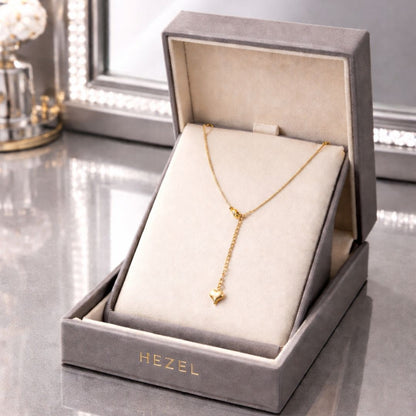 HEZEL luxury gold heart pendant necklace in premium velvet jewelry box with elegant mirror background