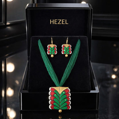 HEZEL handcrafted necklace and earring set with green and red enamel design displayed in premium black jewelry box