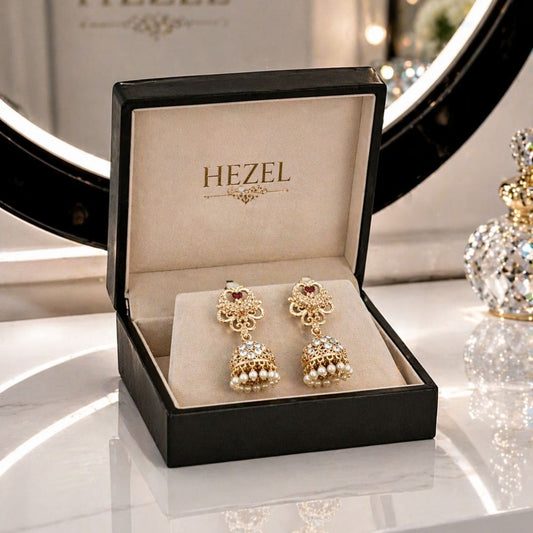Elegant HEZEL traditional jhumka earrings featuring pearl accents and fine craftsmanship, displayed in a premium signature box