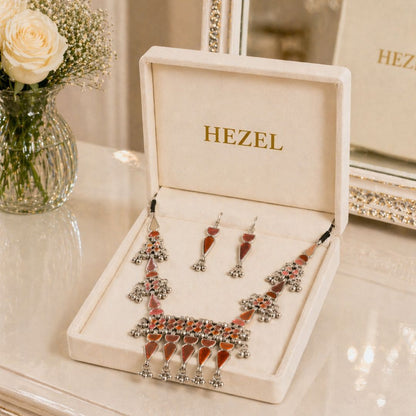 Elegant HEZEL tribal-inspired necklace featuring red enamel detailing and ghungroo-style elements, paired with coordinated earrings