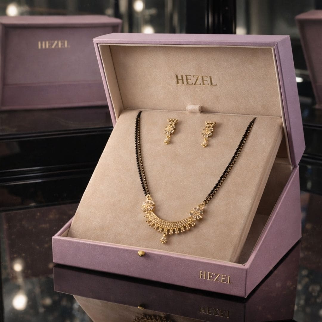 HEZEL black bead mangalsutra set with gold pendant and matching earrings in a premium lavender jewelry box.