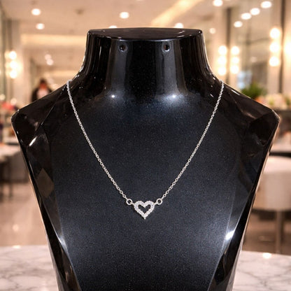 HEZEL heart pendant necklace in silver finish displayed on a black mannequin, elegant minimal jewelry design