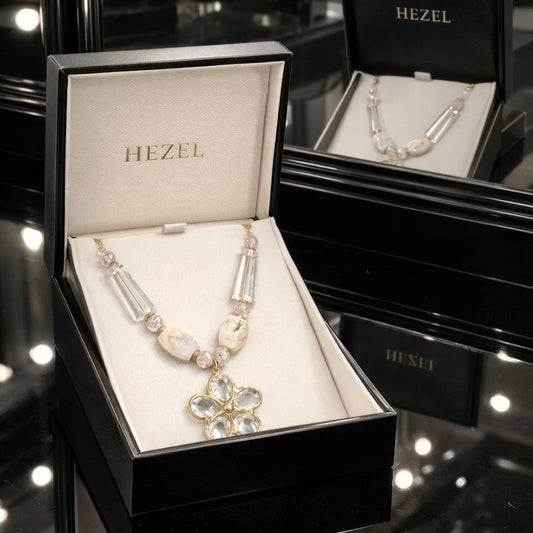 HEZEL luxury crystal necklace with floral pendant, elegantly presented in a premium jewelry box with mirror reflection