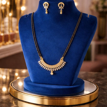 premium mangalsutra jewellery display for Hezel featuring elegant gold detailing, royal blue velvet styling, and luxurious warm lighting aesthetic