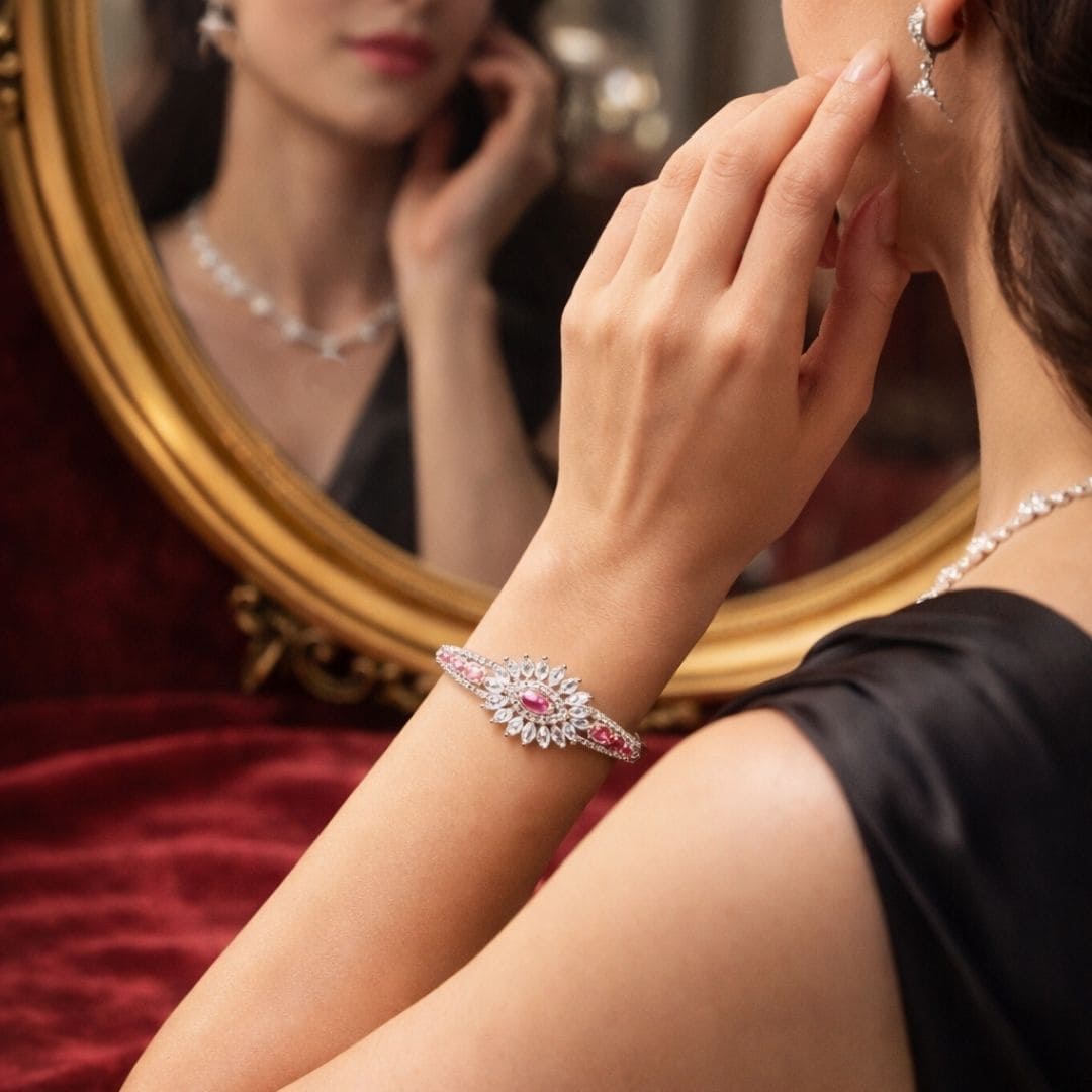 Hezel luxury bracelet on elegant woman with mirror reflection and ruby detailing.