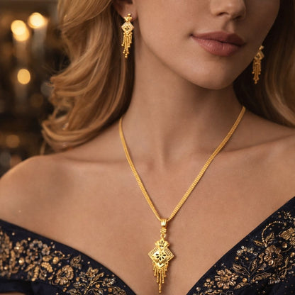 Elegant HEZEL gold pendant necklace and matching earrings styled with luxurious black embroidered outfit