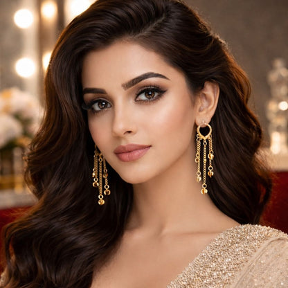Hezel gold chain drop earrings for women with elegant party wear styling, glamorous makeup, and luxury fashion portrait.