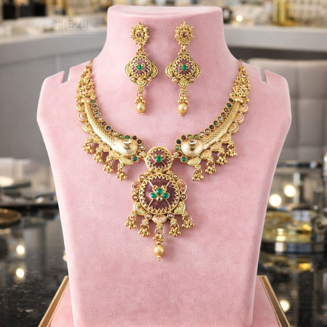 Hezel traditional gold bridal jewelry set with intricate antique design, green stone detailing, and matching statement earrings for wedding wear