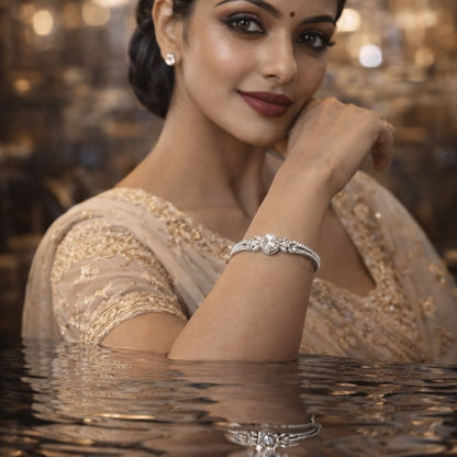 Elegant woman wearing a premium silver crystal bracelet with luxury festive lighting and reflective water effect for Hezel Jewellery