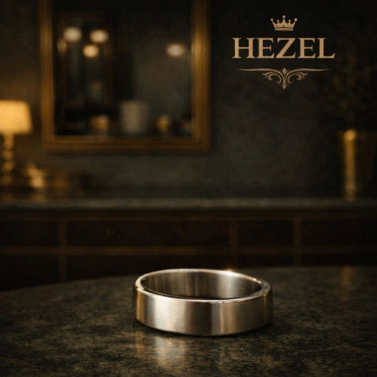 Minimalist silver band ring placed on a premium surface with elegant HEZEL branding in the background, highlighting its clean and timeless design
