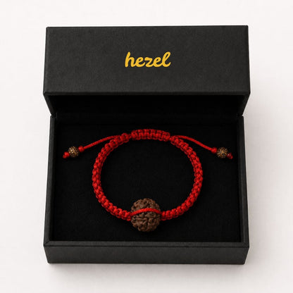 Close-up of HEZEL rudraksha bracelet featuring natural bead and handcrafted red braided cord