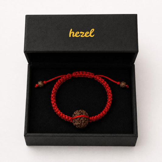 Close-up of HEZEL rudraksha bracelet featuring natural bead and handcrafted red braided cord