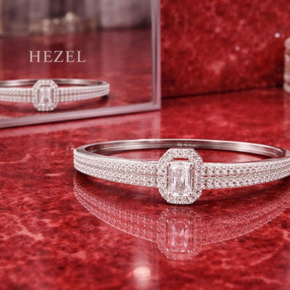 Premium silver crystal bracelet with elegant diamond detailing displayed on glossy red reflective surface for Hezel Jewellery.