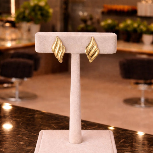 HEZEL gold leaf design stud earrings displayed on premium jewelry stand