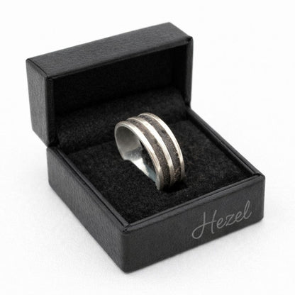 HEZEL silver band ring with textured center stripe displayed in black leather jewelry box on clean white background