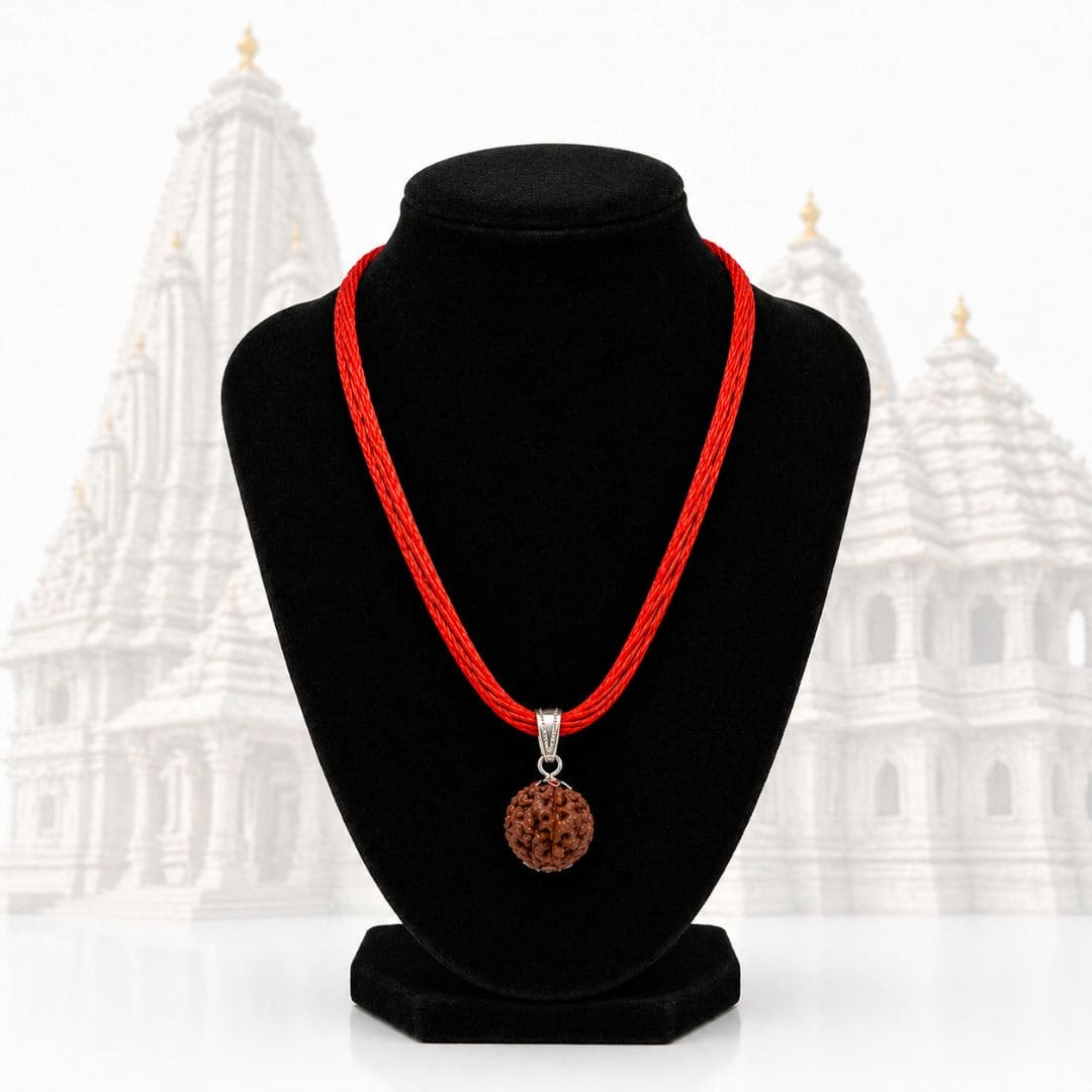 Close-up of HEZEL rudraksha pendant necklace with detailed bead texture and red thread cord