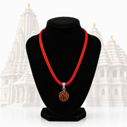 Close-up of HEZEL rudraksha pendant necklace with detailed bead texture and red thread cord