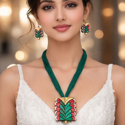 HEZEL green and red enamel necklace with matching earrings worn by female model in elegant festive attire close-up